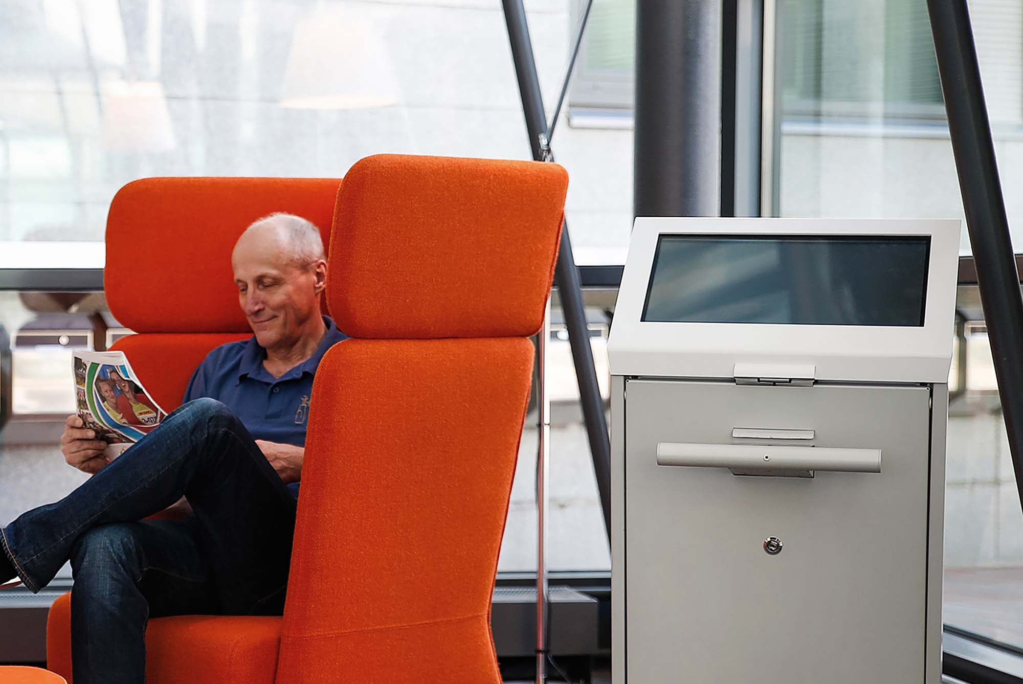 Patient waiting for his turn next to a self-service kiosk