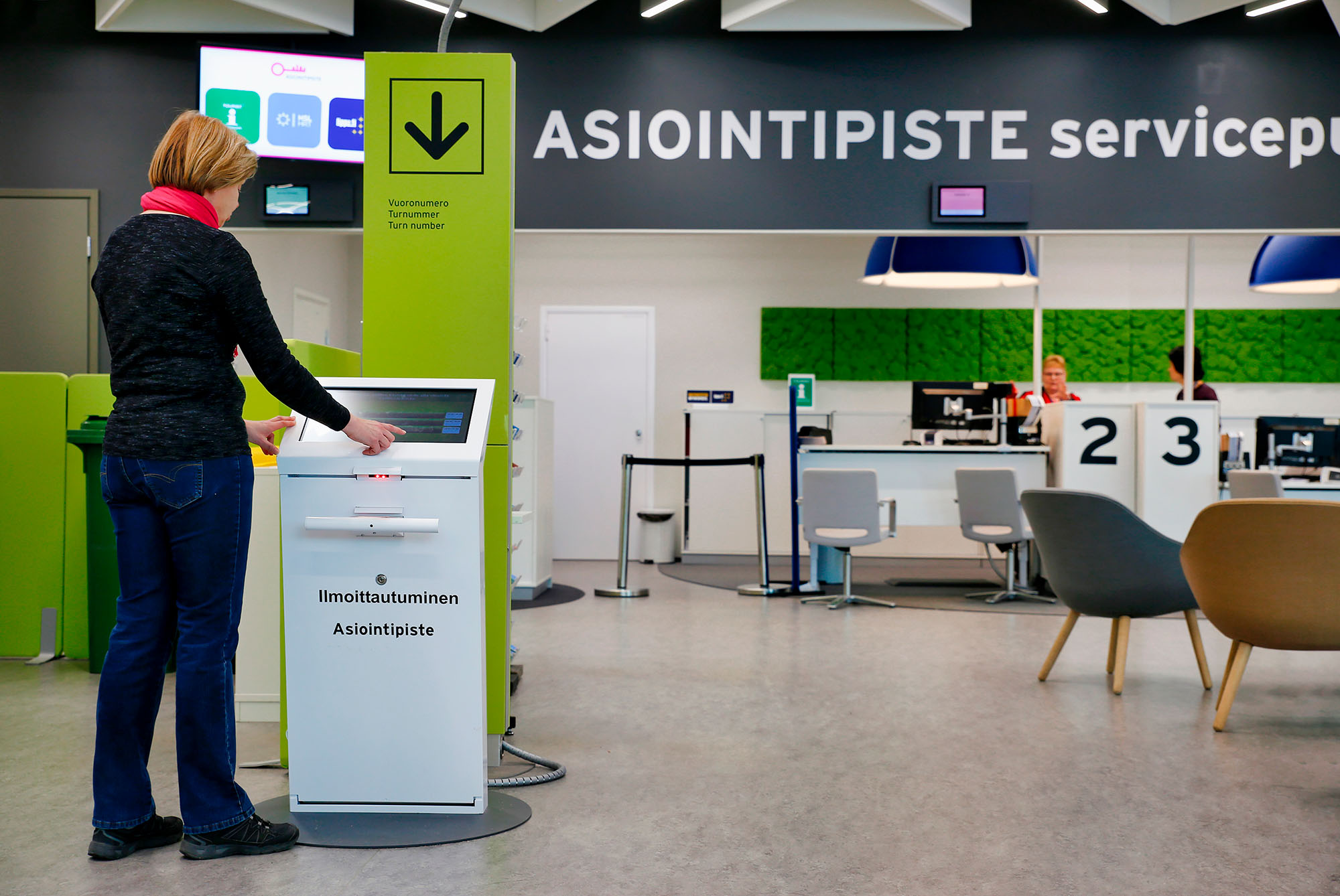 Person checking in at a self-service kiosk